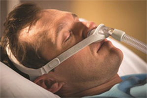 Picture of man sleeping with nasal pillow mask